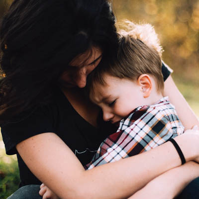 Woman embracing child
